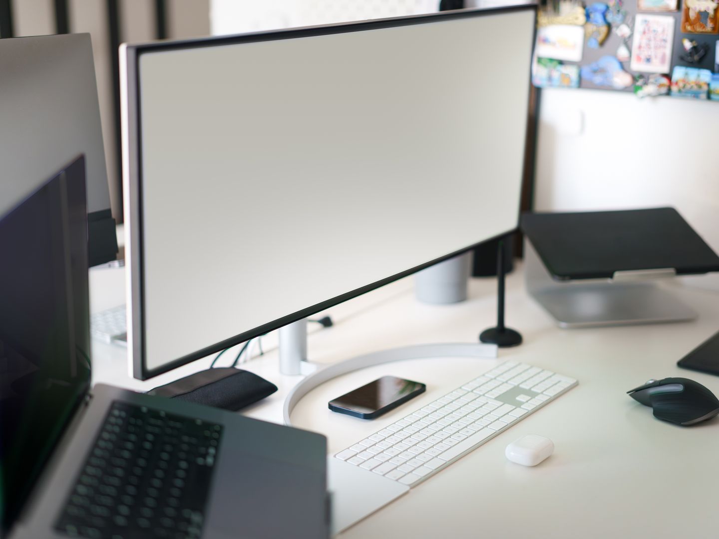 Clean and modern office workspace featuring a desktop setup with a large monitor and accessories.